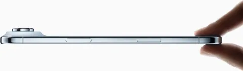 Apple iPhone Air in Sky Blue, fingers pinching the ultra-thin edge