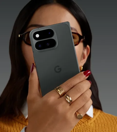 Google Pixel 11 Pro Fold in Obsidian, unfolded in-hand with both hands, camera bar visible