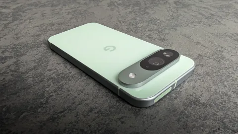 Google Pixel 9 in Wintergreen resting at an angle on a dark stone surface
