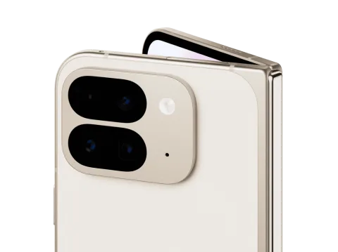 Angled close-up of Pixel 9 Pro Fold in Porcelain color. The back camera is featured, and the internal screen peaks out over the top.