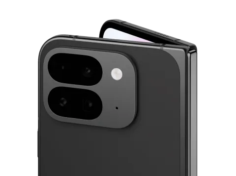 Angled close-up of Pixel 9 Pro Fold in Obsidian color. The back camera is featured, and the internal screen peaks out over the top.
