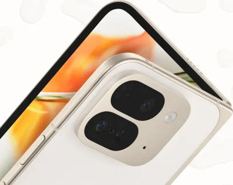 Angled, top-down view of open Pixel 9 Pro Fold in Porcelain color. The back camera is featured, and the internal screen peaks out over the top.