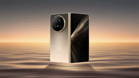 Honor Magic V5 folded, Gold colourway, standing on a beach