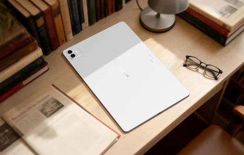 Honor MagicPad 4 on a desk with books, white colourway