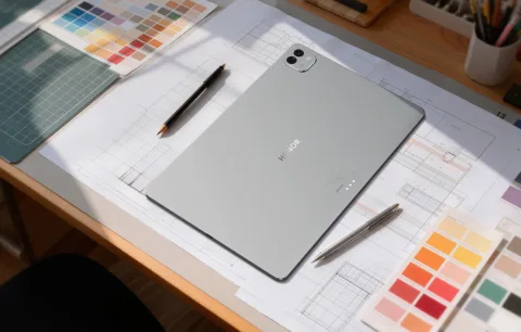 Honor MagicPad 4 on a desk with design tools, grey colourway