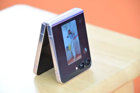 Samsung Galaxy Z Flip5 in Lavender, propped open on a table showing Flex Window