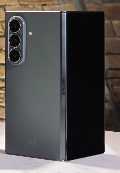 Samsung Galaxy Z Fold8 Ultra in Graphite, half-open, triple rear camera visible, on display at Galaxy Unpacked July 2026
