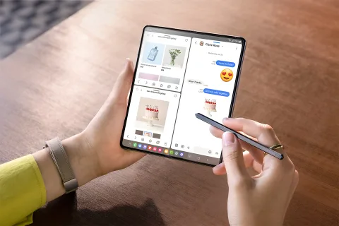 Person using an open Galaxy Z Fold5 in multi-window split screen with S Pen