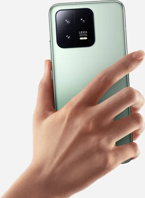 Xiaomi 13 in Green, back view held in hand