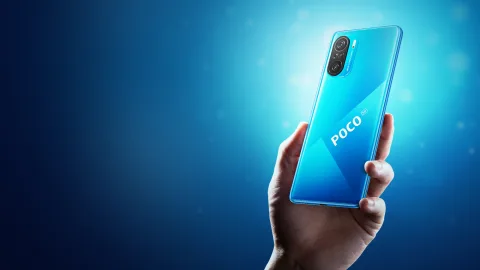 POCO F3 in Blue, held in hand showing back view