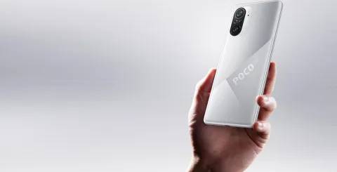 POCO F3 in Silver, held in hand showing back view