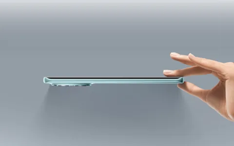 POCO M8 side profile held between fingers showing thinness