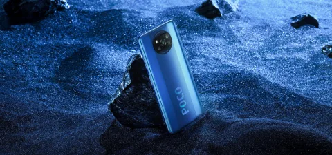 POCO X3 NFC in Cobalt Blue, back view resting on a rock